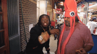 Man In Octopus Costume Talking To Man In Black Shirt GIF