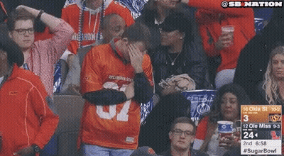 Man In Oklahoma State Jersey Covering Face GIF