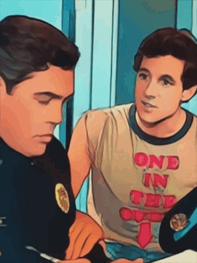 Man In One In The Oval T-Shirt Talks To Another Man GIF