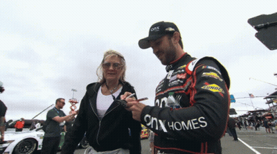 Man In ONX Homes Jacket Signing Woman's Hand GIF
