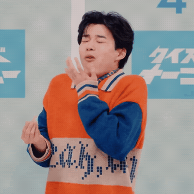 Man In Orange And Blue Sweater Making Funny Face GIF