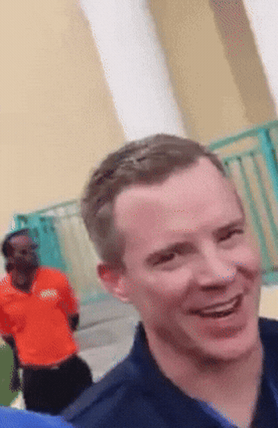 Man In Orange Boss Shirt Smiling GIF
