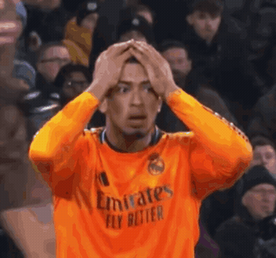 Man In Orange Emirates Fly Better Jersey Holding Head GIF