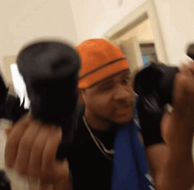 Man In Orange Hard Hat Holding Two Flashlights GIF