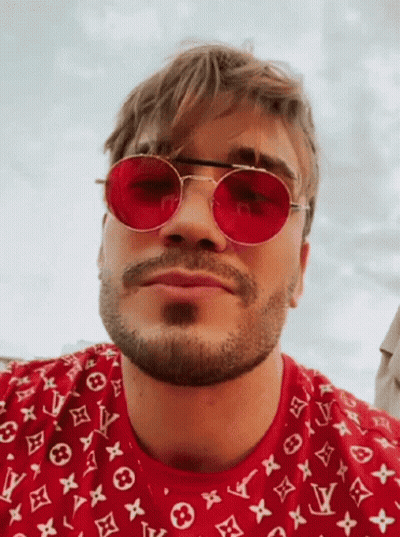 Man In Orange Hoodie And Black 101 Des Shirt At Microphone GIF
