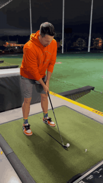 Man In Orange Hoodie Playing Golf GIF