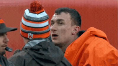 Man In Orange Jacket And Hat Talking To Another Man GIF