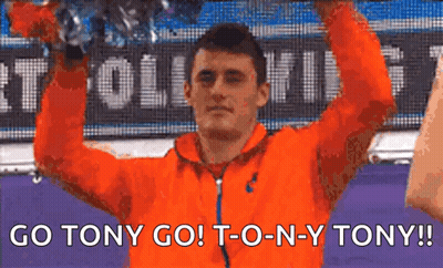 Man In Orange Jacket Holding Trophy GIF