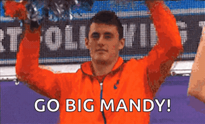 Man In Orange Jacket Holding Trophy Saying Go Big Mandy GIF