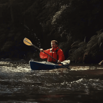 Man In Orange Jacket Paddling Blue Kayak GIF