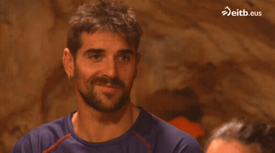 Man In Orange Jacket Standing On Hillside GIF