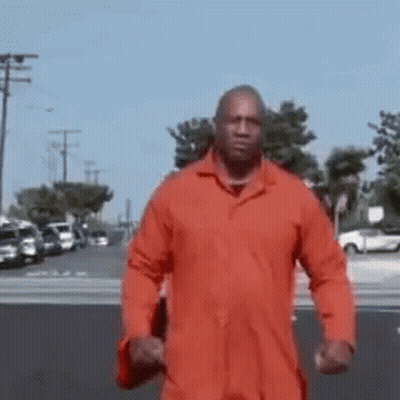 Man In Orange Jacket Walking GIF