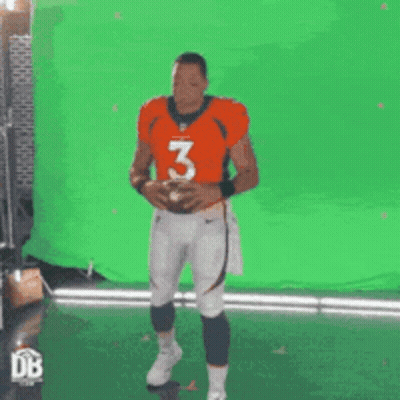 Man In Orange Jersey Number 3 Holding Football GIF