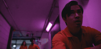 Man In Orange Jumpsuit Running Down Hallway GIF