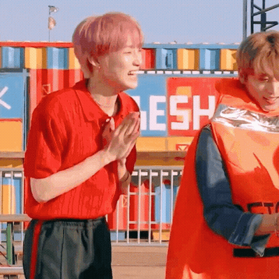 Man In Orange Life Vest Standing Next To Another Man GIF
