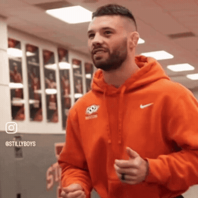 Man In Orange Nike Hoodie Standing In Gym GIF