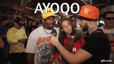 Man In Orange NY Hat Talking To Woman GIF