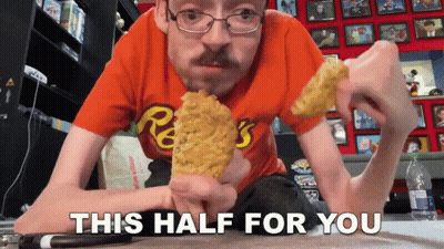 Man in Orange Reese's Shirt Eating Corn