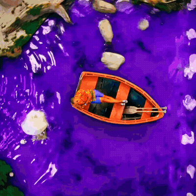 Man In Orange Shirt And Blue Shorts Laying On Boat GIF