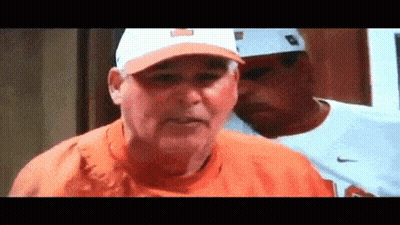 Man In Orange Shirt And Hat Beside Nike Shirt Man GIF