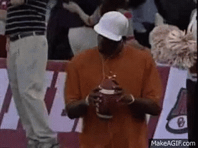 Man In Orange Shirt And White Hat Holding Football GIF