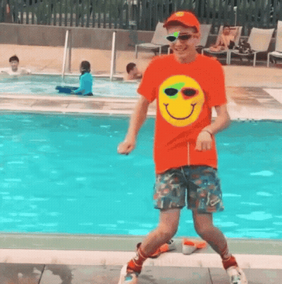 Man In Orange Shirt Dancing Near Pool GIF