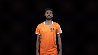 Man In Orange Shirt Flexing Muscles Saying FC Goa GIF