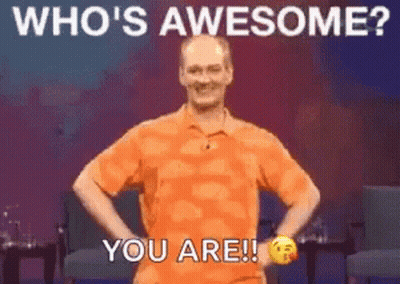 Man In Orange Shirt Hands On Hips Saying Whos Awesome You Are GIF