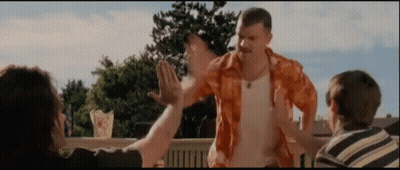 Man In Orange Shirt High Fiving Two People GIF