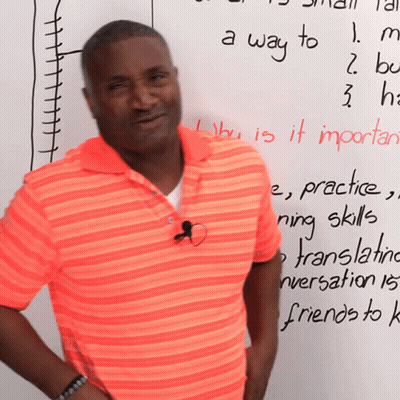 Man In Orange Shirt In Front Of A Way To Whiteboard GIF