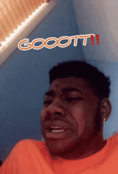 Man In Orange Shirt Making Funny Face Gocott GIF