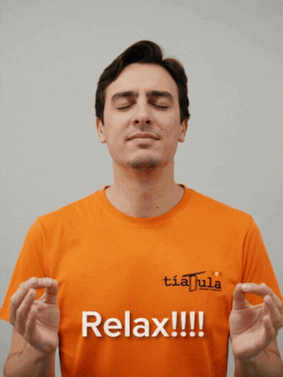 Man In Orange Shirt Saying Relax With Eyes Closed GIF