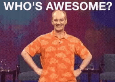 Man In Orange Shirt Saying Who's Awesome GIF