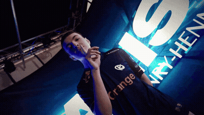 Man In Orange Shirt Standing In Front Of Sign GIF