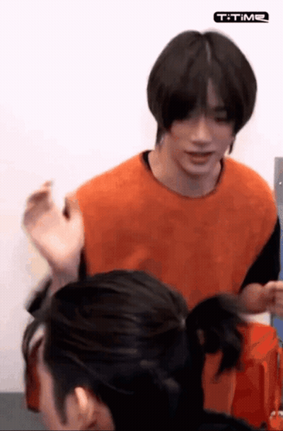 Man In Orange Shirt Standing With Woman GIF