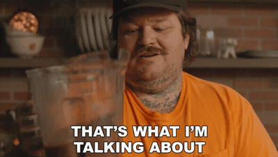 Man In Orange Shirt Talking GIF