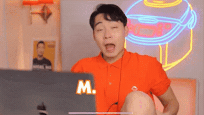 Man In Orange Shirt Using Laptop GIF