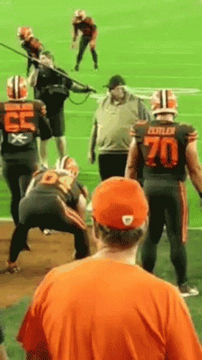 Man In Orange Shirt Watching Football Game GIF