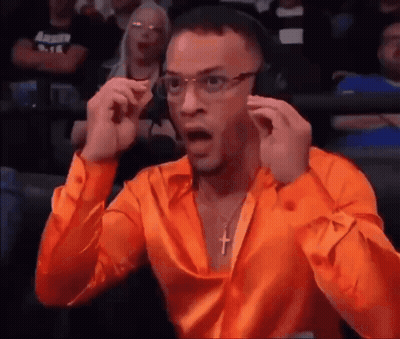 Man In Orange Shirt Wearing Headphones And Cross Necklace GIF