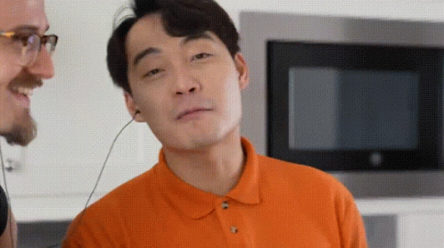 Man In Orange Shirt Wearing Headphones GIF