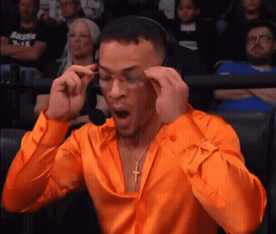 Man In Orange Shirt With Cross Necklace And Headphones GIF