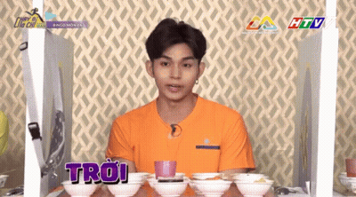 Man In Orange Shirt With Troi Bowls GIF