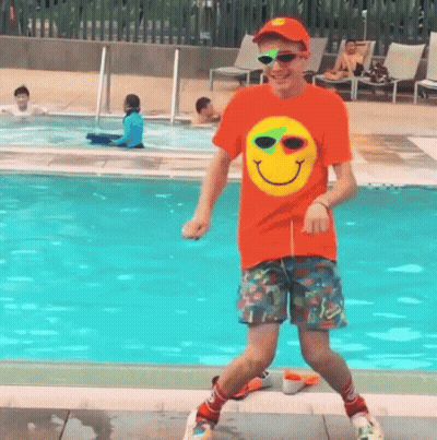 Man In Orange Smiley Shirt Dancing GIF