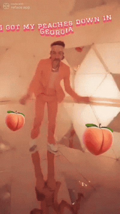 Man In Orange Suit In Front Of Mirror With Peaches GIF