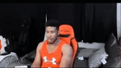 Man In Orange Under Armour Tank Top In Gaming Chair GIF