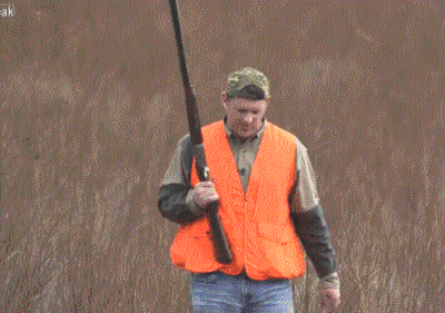 Man In Orange Vest Holding Gun GIF