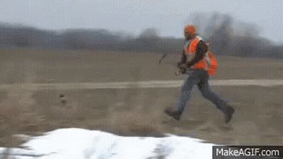 Man In Orange Vest Running In Field GIF