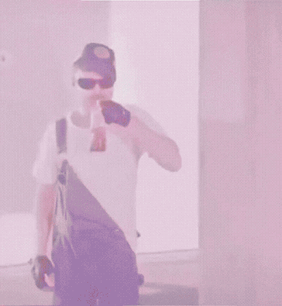 Man In Overalls And Blue Hat Holding Sword In Mouth GIF
