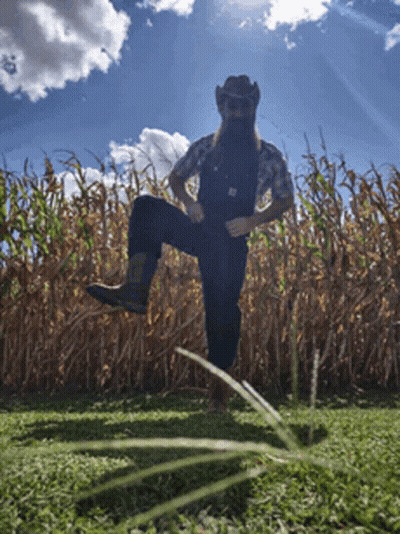 Man In Overalls And Cowboy Hat In Cornfield GIF