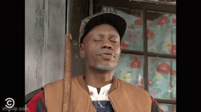Man In Overalls And Hat Holding Cane By Window GIF